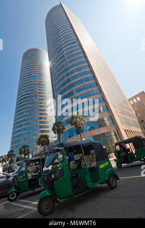 Vertical view of the World Trade centre buildings in Colombo, Sri Lanka with rickshaws parked on the street outside. Stock Photo
