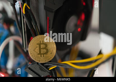 bitcoin on the background of a graphics card in a rack for crypto-currency mining Stock Photo