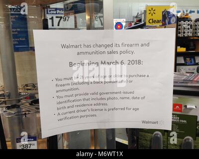 Lecanto, Florida - March 6, 2018: A Walmart Supercenter posts a sign announcing their new firearm and ammunition sales policy.  In order to purchase a firearm or ammunition you must now be 21 years of age or older. Credit: Brian Parker/Alamy Live News Stock Photo