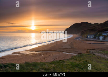 Seatown, Dorset, UK. 6th March 2018.  UK Weather.   A beam of sunlight shines up on the high level clouds which are partially obscuring the sunset at Seatown on the Jurassic Coast of Dorset.  Picture Credit: Graham Hunt/Alamy Live News Stock Photo