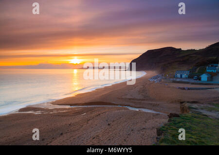 Seatown, Dorset, UK. 6th March 2018.  UK Weather.   High level clouds partially obscures the sunset at Seatown on the Jurassic Coast of Dorset.  Picture Credit: Graham Hunt/Alamy Live News Stock Photo