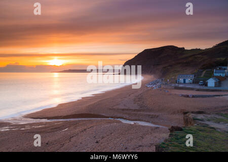 Seatown, Dorset, UK. 6th March 2018.  UK Weather.   High level clouds partially obscures the sunset at Seatown on the Jurassic Coast of Dorset.  Picture Credit: Graham Hunt/Alamy Live News Stock Photo