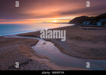 Seatown, Dorset, UK. 6th March 2018.  UK Weather.   High level clouds partially obscures the sunset at Seatown on the Jurassic Coast of Dorset.  Picture Credit: Graham Hunt/Alamy Live News Stock Photo