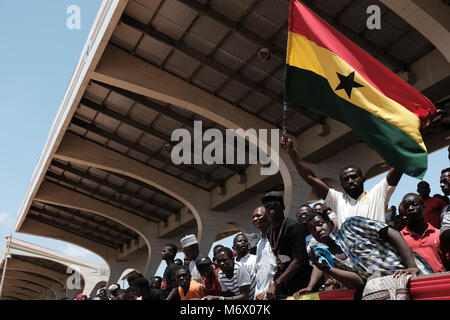 Accra, March 6. 6th Mar, 1957. A man waves national flag of Ghana during Ghana's 61st independence anniversary parade in Accra, capital of Ghana, March 6, 2018. Ghana gained independence from British rule on March 6, 1957. Credit: Francis Kokoroko/Xinhua/Alamy Live News Stock Photo