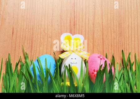 Easter funny bunny on green grass and easter eggs. Easter background Stock Photo