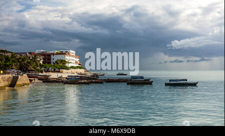 Stone Town, Zanzibar - February 8, 2017: Seafront with boats on calm sea. Stock Photo