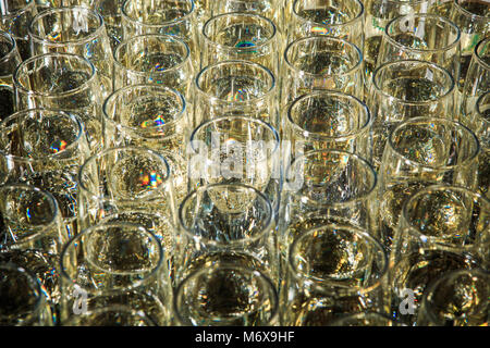 closeup set of filled champagne glasses arranged in rows on catering service banquet Stock Photo