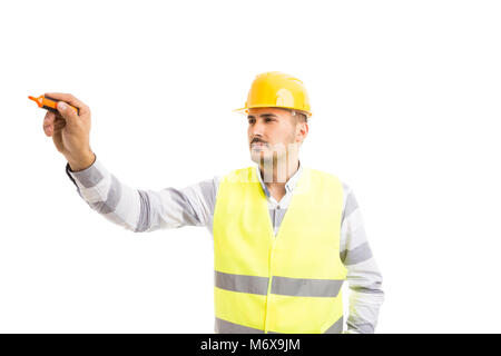 Handsome young architect holding and writing with marker pen  isolated on white copyspace background Stock Photo