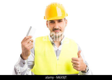 Architect or contractor holding debit credit card smiling and showing thumb up like gesture Stock Photo