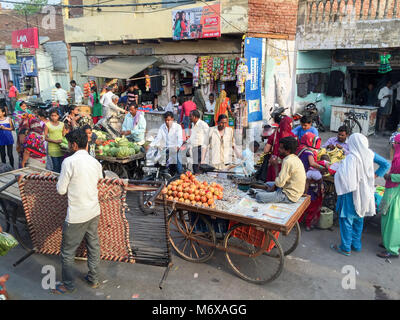 Indians in traditional dress buy and sell at a street market in Agra, India Stock Photo