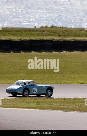 Classic sports car speeding around the Anglesey motor racing circuit, Ty Croes, Anglesey, Wales, June Stock Photo