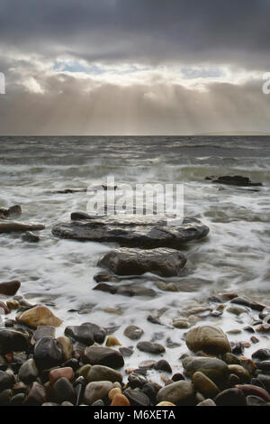 A break from the storm. Waves crashing into the beach at Elgol on the Isle of Skye, Scotland. Stock Photo