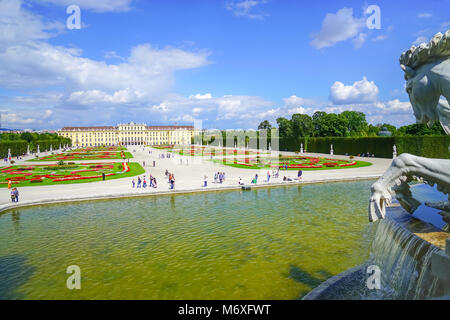 VIENNA,AUSTRIA - SEPTEMBER 4 2017; Tourists in grounds beyond large pond and horse statue of Baroque architectural e Schonbrunn imperial palace, one o