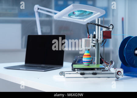 3D printer and computer on the table Stock Photo