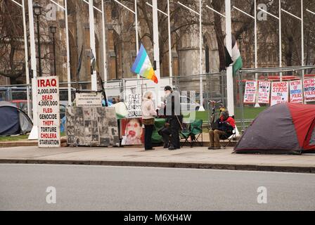 Various protestors stands opposite the Houses of Parliament in Parliament Square, London on March 17, 2011. Stock Photo