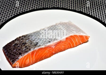 Raw Salmon steak / fillet on a white plate Stock Photo
