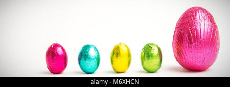 Four small easter eggs beside large one Stock Photo
