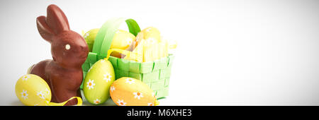 Easter eggs in a basket with chocolate bunny Stock Photo