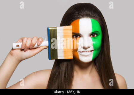 Female supporter in the national colors of Côte d'Ivoire Stock Photo