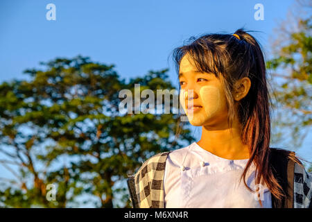 Portrait of a smiling beautiful young woman wearing Thanaka, the yellow face paste Stock Photo