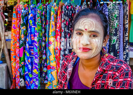 Portrait of a smiling beautiful young woman wearing Thanaka, the yellow face paste Stock Photo