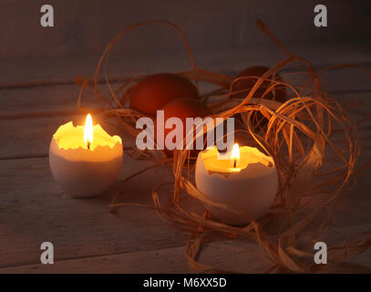 Rustic composition with candles and eggs. Happy easter. Selective focus. Stock Photo