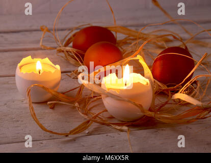Rustic composition with candles and eggs. Happy easter. Selective focus. Stock Photo