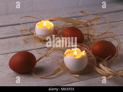 Rustic composition with candles and eggs. Happy easter. Selective focus. Stock Photo