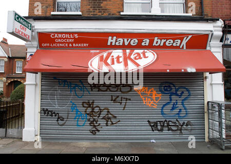 Metal shutters on closed shop covered in graffiti London, England. 2005 Stock Photo