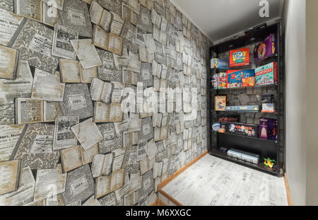 MOSCOW - JULY 2014: Interior of the hookah and anticafe 'MELLOW-YELLOW'. Bookcase with Board games Stock Photo