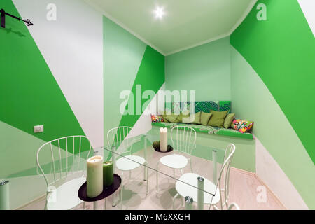 MOSCOW - JULY 2014: Interior of the hookah and anticafe 'MELLOW-YELLOW'. Green room with sofa and glass table Stock Photo