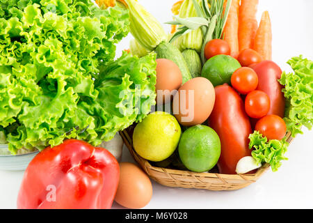 Fresh and ripe vegetables arranged in a basket isolated on white Stock Photo