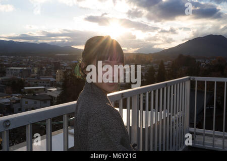 Beautiful girl in a yukata with the view of Mount Fuji during sunset Stock Photo