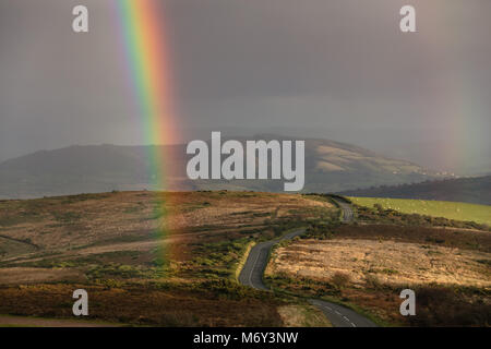 A rainbow over Porlock Hill, Exmoor, Somerset, England, UK Stock Photo