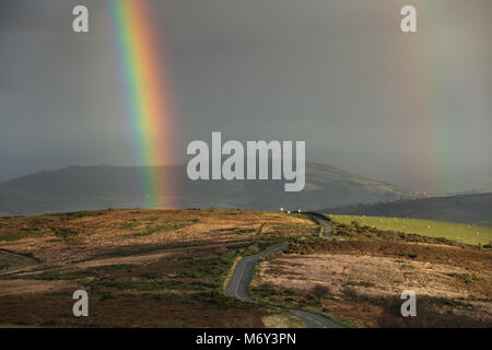 A rainbow over Porlock Hill, Exmoor, Somerset, England, UK Stock Photo