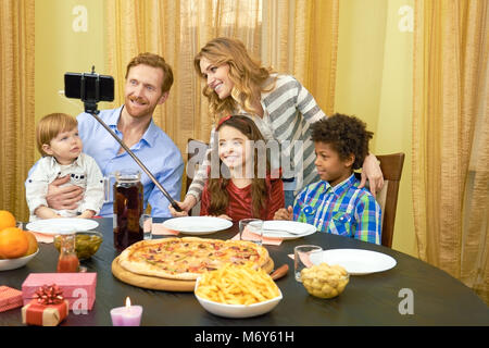 Family taking a selfie, dinner. Stock Photo