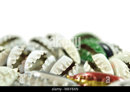 Folded metalic bottle caps isolated on white background Stock Photo