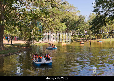 Horizontal view of people in pedaloes in Viharamahadevi Park, formerly known as Victoria Park in Colombo, Sri Lanka. Stock Photo