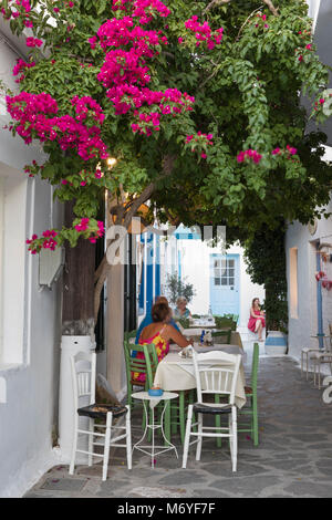 Outdoor restaurant framed by colourful bougainvillea in the old town, Plaka, Milos, Cyclades, Aegean Sea, Greek Islands; Greece; Europe Stock Photo