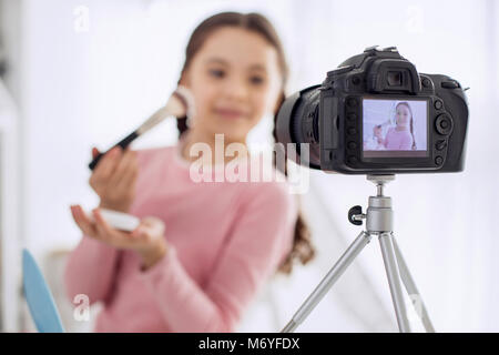 Professional camera filming girl making makeup tutorial Stock Photo