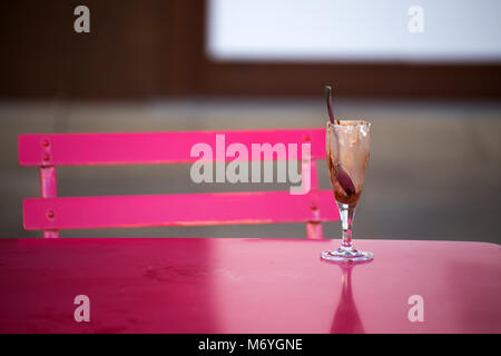 Dirty glass of ice cream on a table background Stock Photo