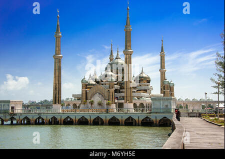 The Crystal Mosque (Masjid Kristal) in Koala Terengganu, Malaysia. Golden minarets sparkle in the sun against a blue sky background Stock Photo