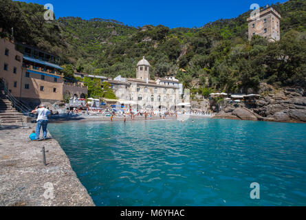 SAN FRUTTUSO DI CAMOGLI, ITALY, MAY, 4, 2016 - San Fruttuoso di Camogli, Ligurian coast, Genoa province, with its ancient Abbaey, the beach and touris Stock Photo