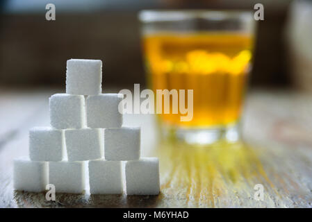 Sugar cubes with apple juice on background. Sugar danger concept Stock Photo
