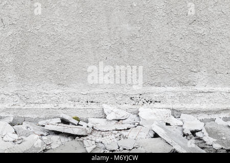 Abstract gray interior background with white grungy plastering on wall and broken concrete pieces Stock Photo