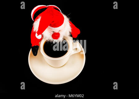 black coffee in a white cup and plush Santa Claus, drink set, tasty drink Stock Photo