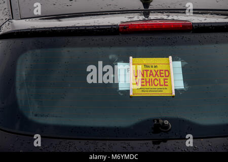 Wheel clamping of untaxed vehicles is becoming more common with the paper tax disc display being abolished and car tax needing to be paid online. Stock Photo