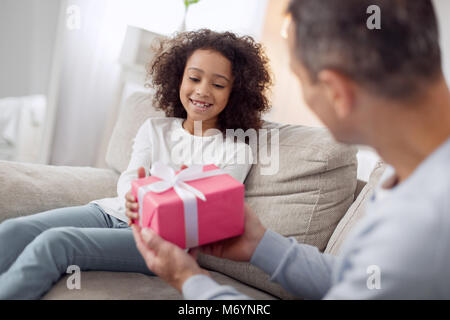 Loving father holding a gift for his daughter Stock Photo