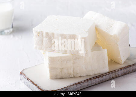 Fresh cottage cheese on rustic white wooden board, homemade organic dairy product Stock Photo