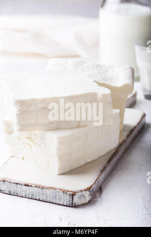 Fresh cottage cheese on rustic white wooden board, homemade organic dairy product Stock Photo